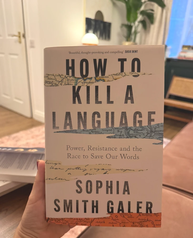 A hand holding How to Kill a Language by Sophia Smith Galer.